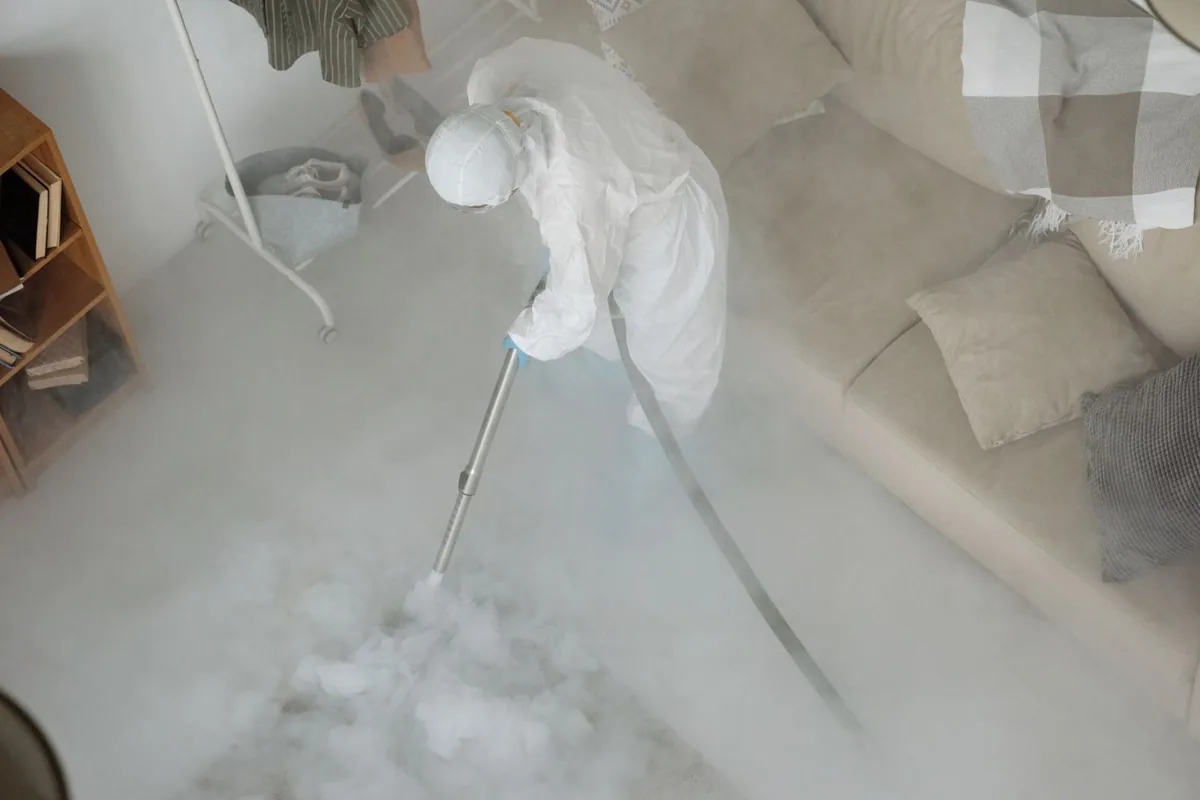Biohazard cleanup technician in protective equipment, Hearne, TX